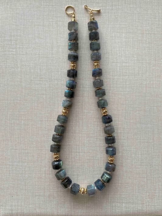Labradorite Necklace with blue beads and gold accents on a light gray background